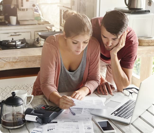 Mujer y hombre haciendo cálculos en una cocina